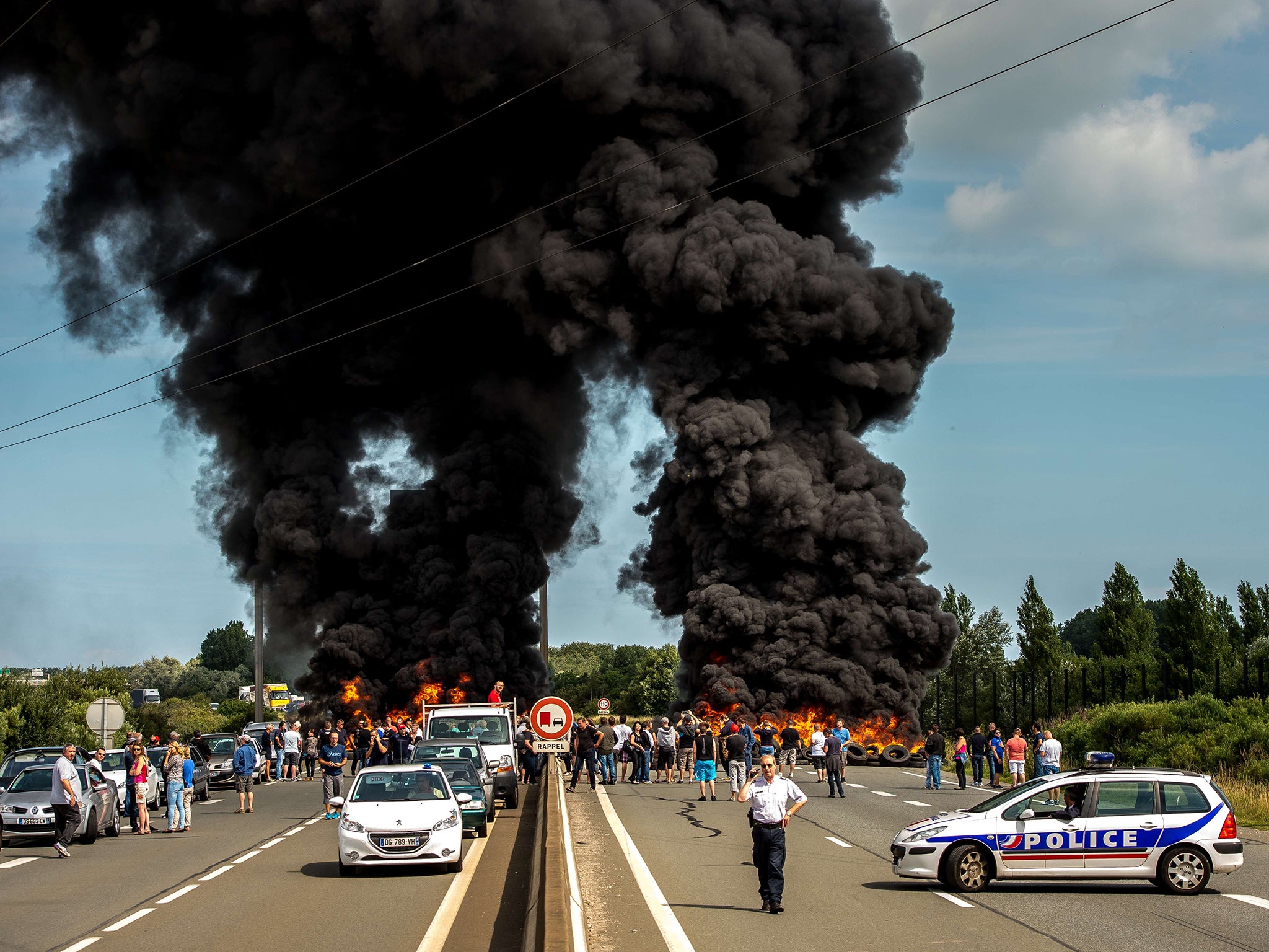 Striking employees of the My Ferry Link company block the access to the harbour after setting tyres on fire in Calais, following the failure of negotiations with French government concerning job cuts