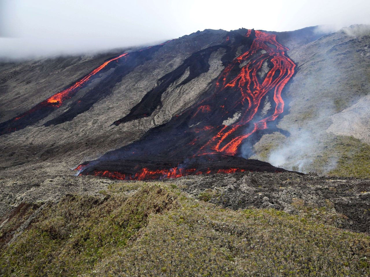 Lava flows out of the Piton de la Fournaise volcano as it erupts on 31 July