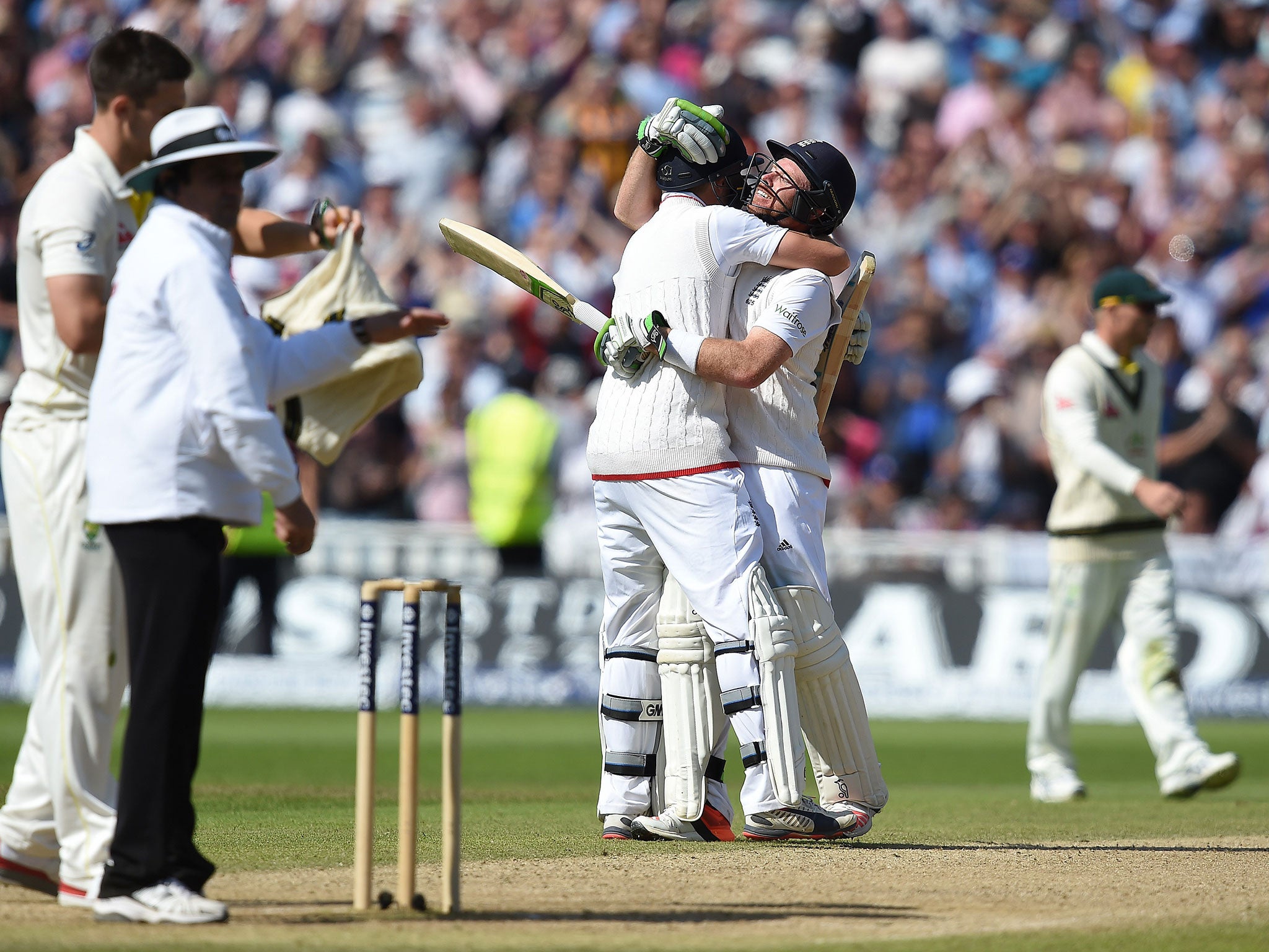 Joe Root and Ian Bell celebrate after adding the winning runs for England on the third day