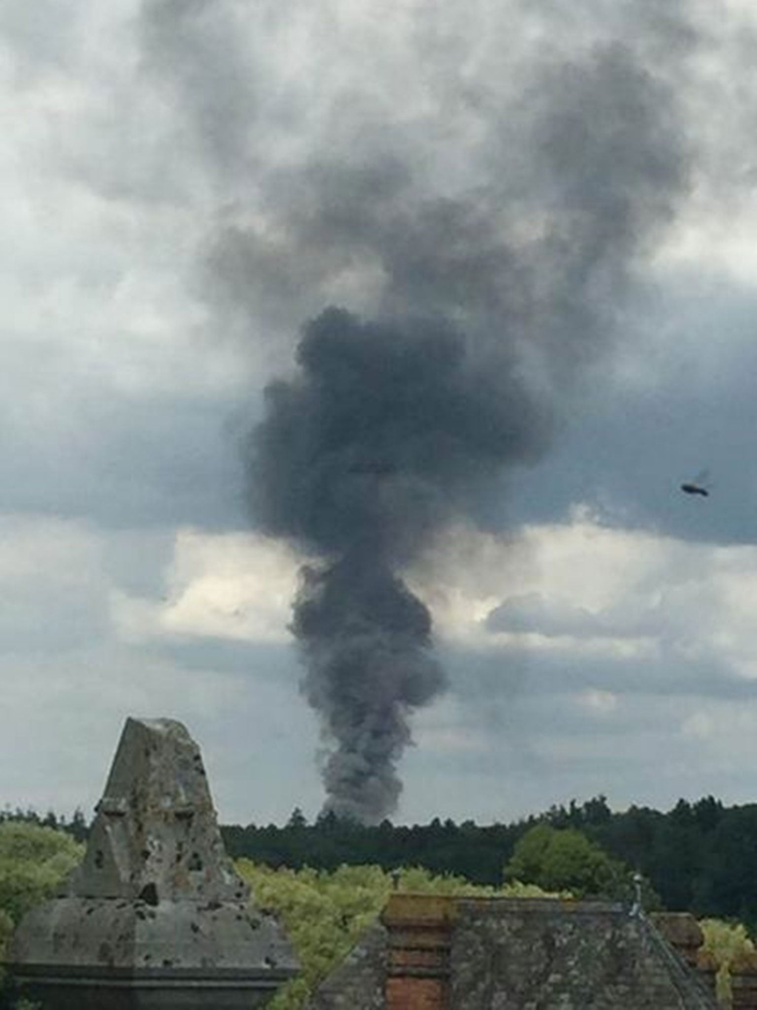 Smoke rising from Blackbushe airport after a light aircraft crashed into a car auction shortly after take-off. (Image: Nathan Greenwood/PA)