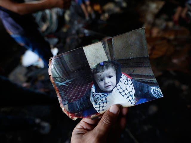 A photograph of 18-month-old Ali Dawabsha in the fire damage home in the West Bank village of Douma near Nablus City, 31 July 2015.