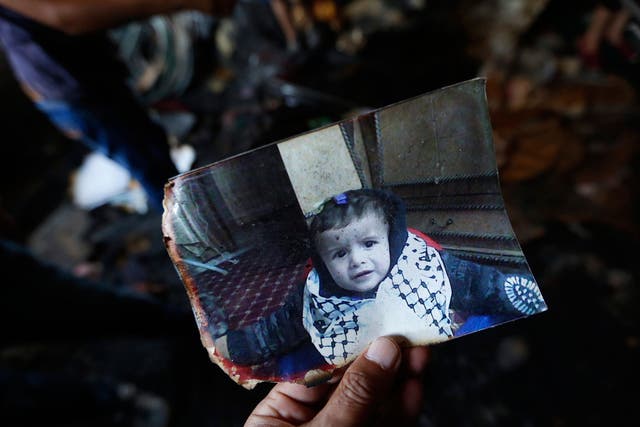 A photograph of 18-month-old Ali Dawabsha in the fire damage home in the West Bank village of Douma near Nablus City, 31 July 2015.