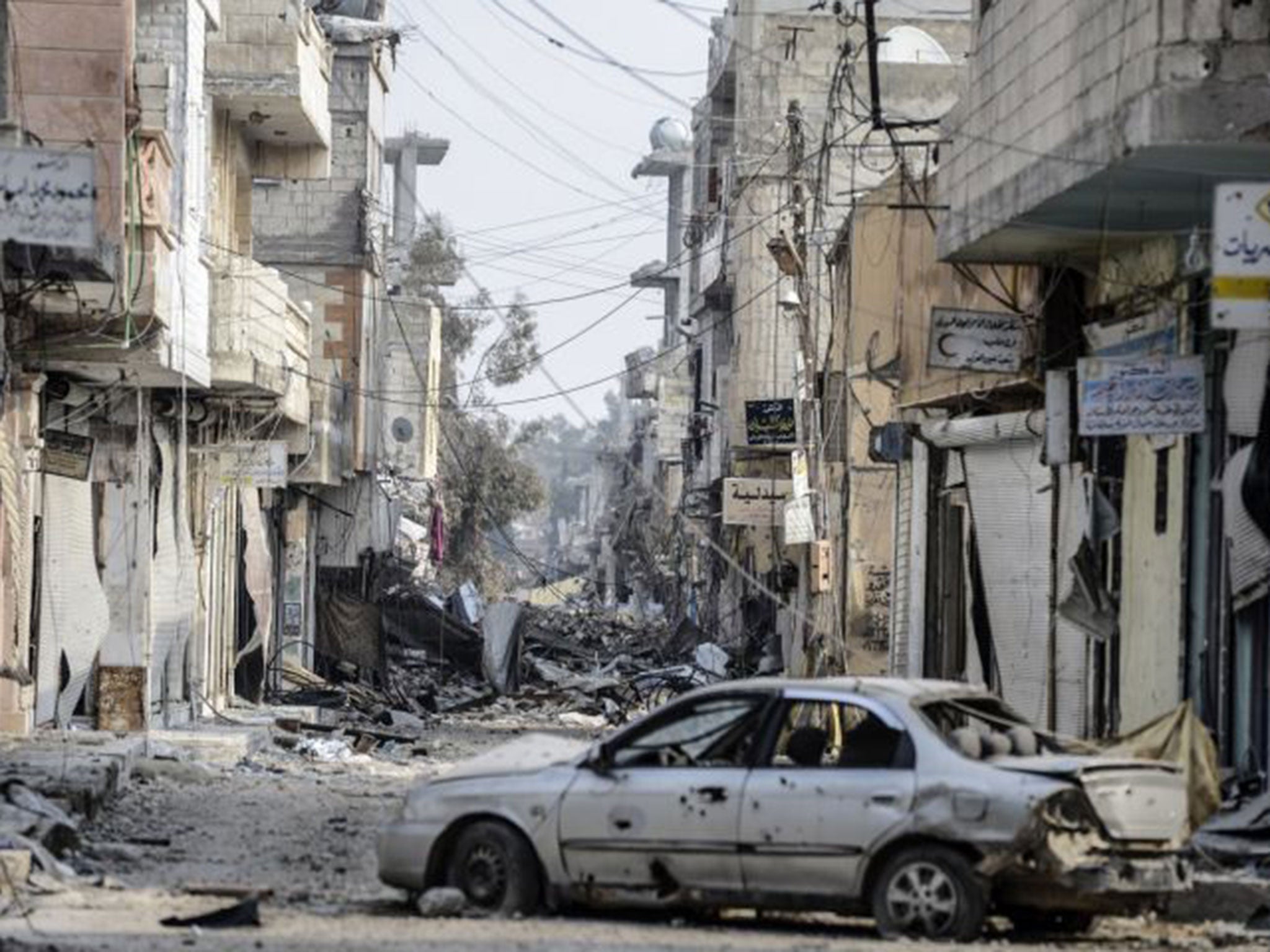 Wreckage left by fighting on a street in the center of the Syrian town of Kobane