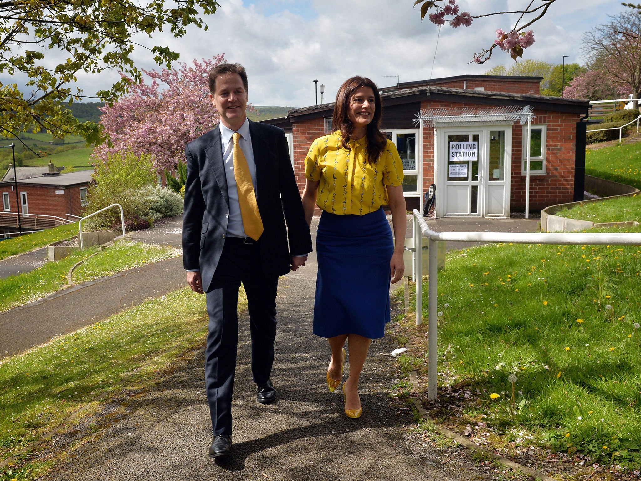Leader of the Liberal Democrat party Nick Clegg (L) and his wife Miriam Gonzalez Durantez leave after voting at Hall Park centre polling station in Sheffield, England on May 7, 2015
