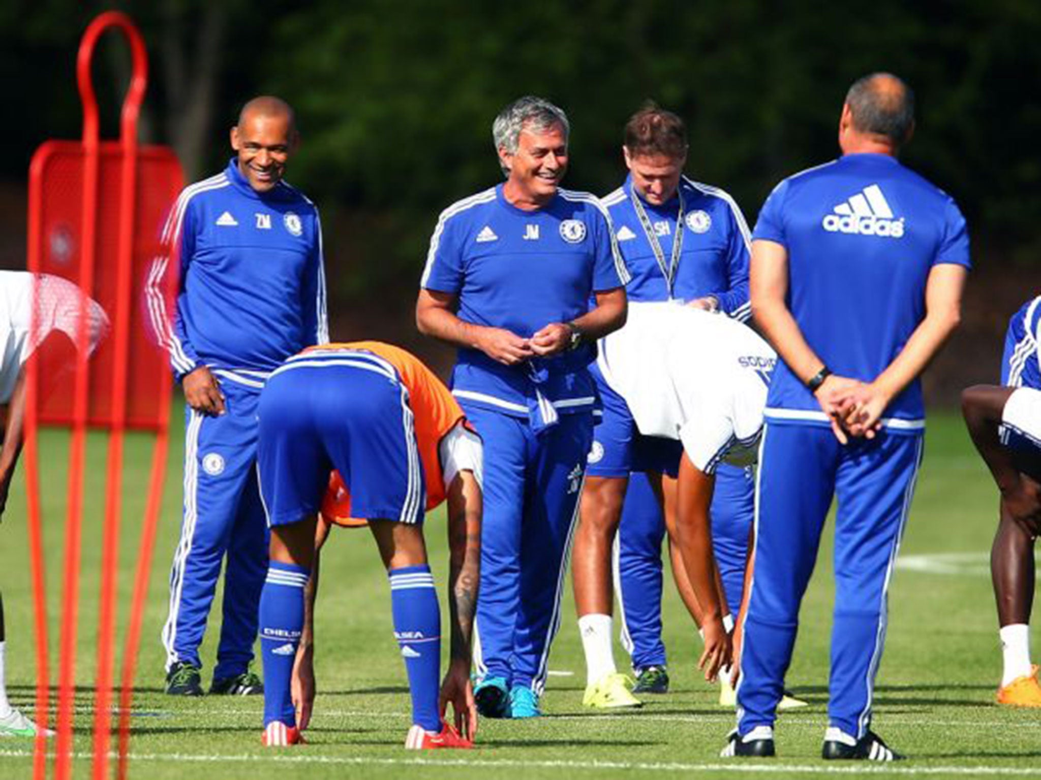 The Chelsea manager, Jose Mourinho, shares a joke with his staff at Cobham yesterday