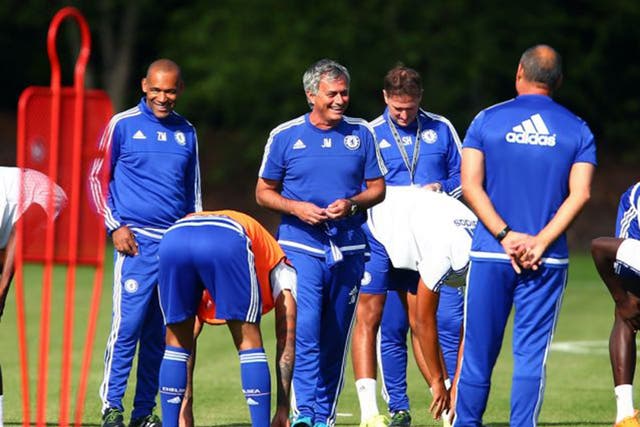 The Chelsea manager, Jose Mourinho, shares a joke with his staff at Cobham yesterday