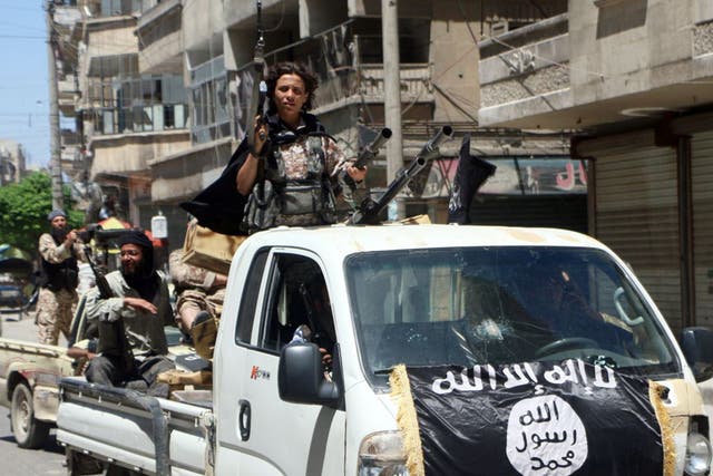Jabhat al-Nusra fighters drive in armed vehicles through the northern Syrian city of Aleppo towards the frontline