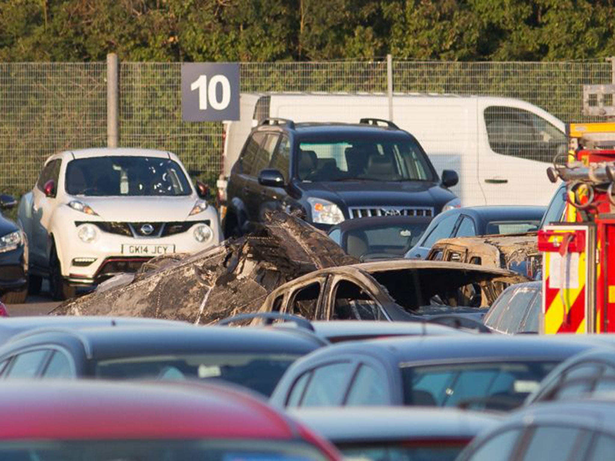 Debris from the jet that crashed into a car auction site on Friday