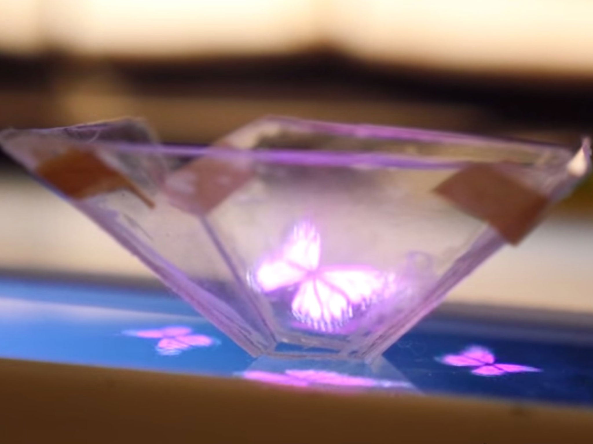 A butterfly hologram appears in the home-made device