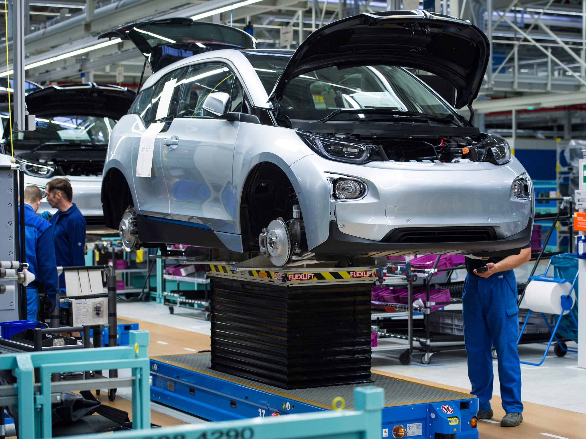 File photo: Workers at BMW factory assemble an i3 electric car
