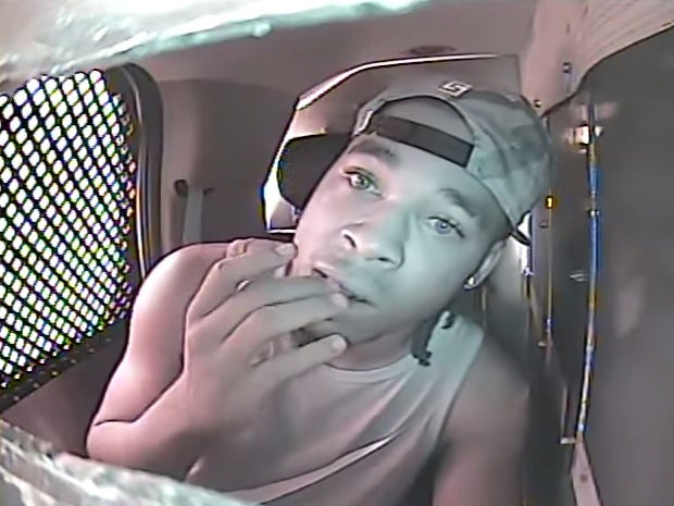 Footage shows Kenzo Roberts desperately chewing his fingertips after being arrested and placed in the back of a Florida police car