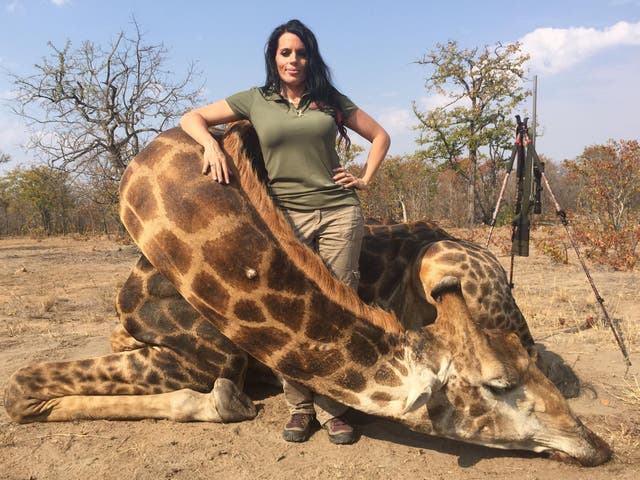 Sabrina Corgatelli poses with the body of the giraffe she killed on safari in South Africa 