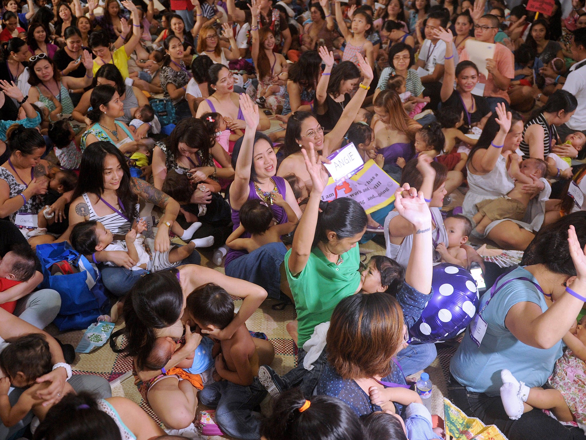 Hundreds of women participate in a mass breastfeeding event in Manila
