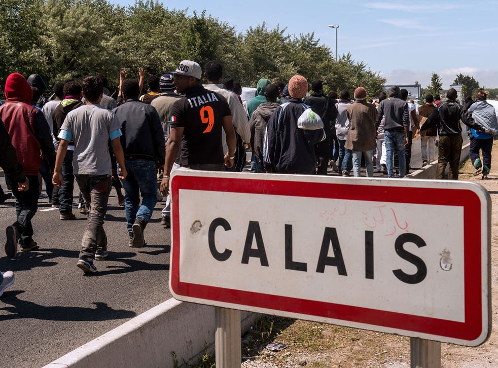 Migrants walk towards the ferry port of Calais, northern France. The move to toughen penalties for renting to illegal immigrants is being hurried into force in response to the chaotic scenes at Calais