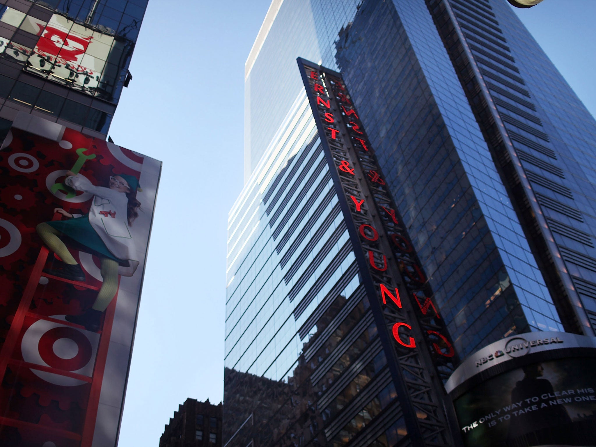 The Ernst and Young building in Times Square. The global accountancy firm says it will not longer consider degrees or A-level results when assessing employees