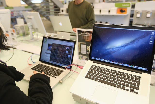 Apple MacBook Pro computers with Retina displays stand at a table at a Gravis Apple retailer on November 6, 2012 in Berlin, Germany