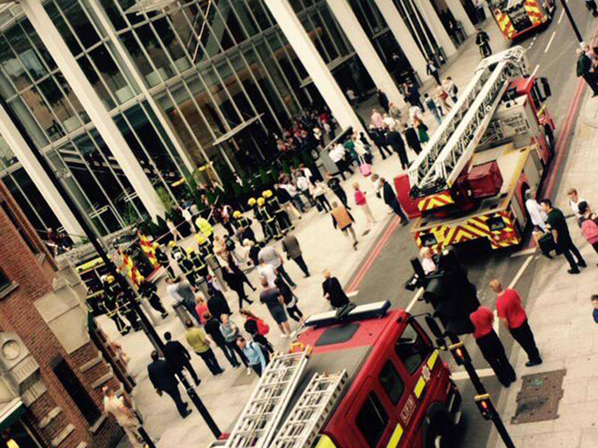 People outside the Shard amongst fire engines called to scene