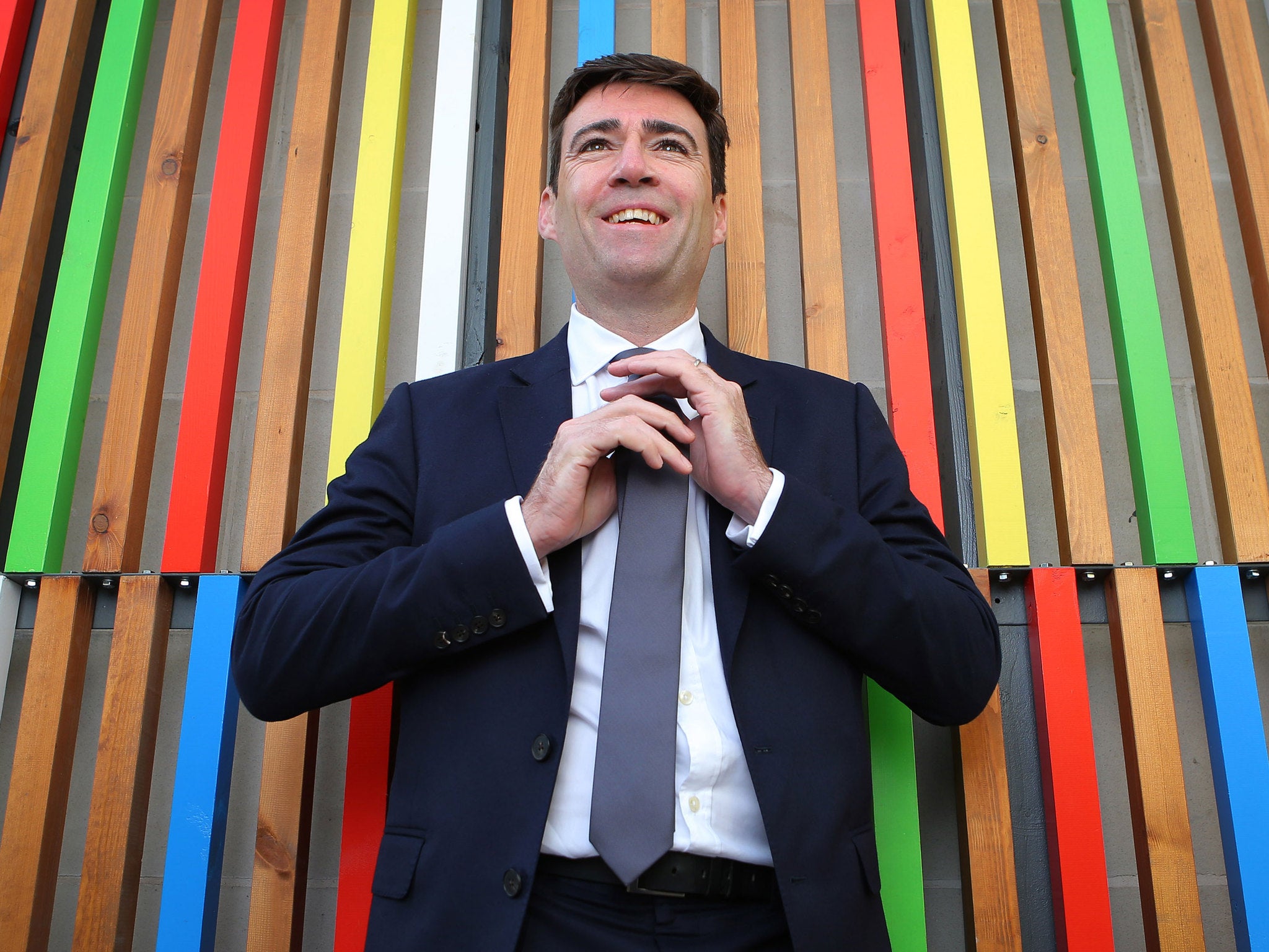 Andy Burnham straightens his tie before a speech in Leeds - but is it Armani or Jaeger