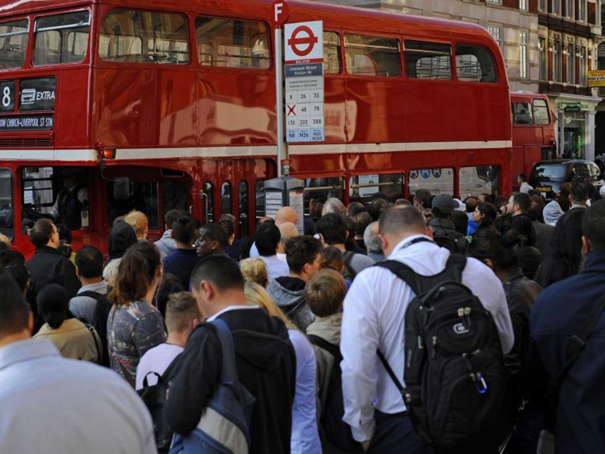 Better to work from home? Employees wait to get onto a bus