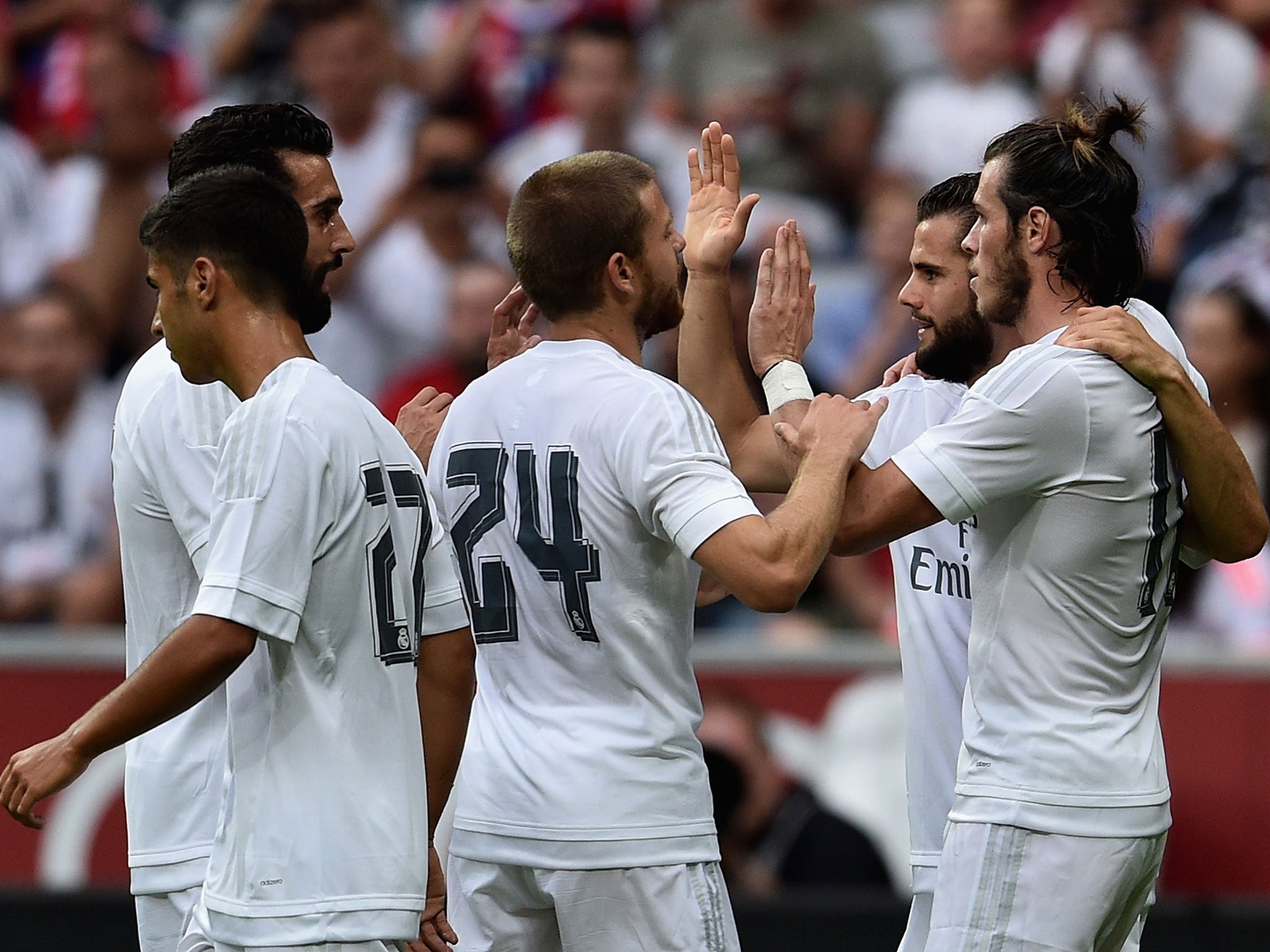 Real Madrid players celebrate with Gareth Bale (far right)