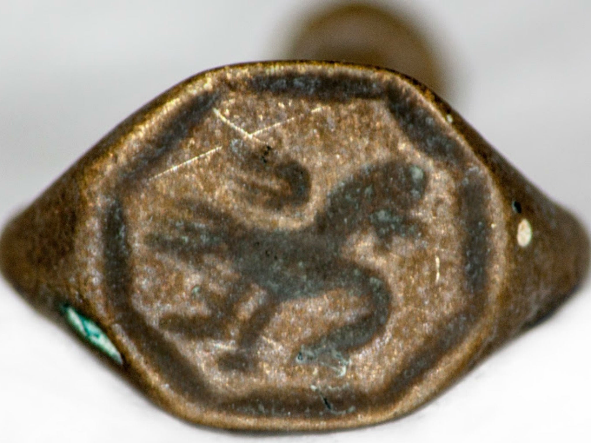 A metal signet pipe tamper ring with a possible griffin figure seal. The seal could be used with wax to impress upon letters and could also be worn as a ring by its owner. The tamper end could also be used for tamping down pipe tobacco when packing the bowl of the pipe