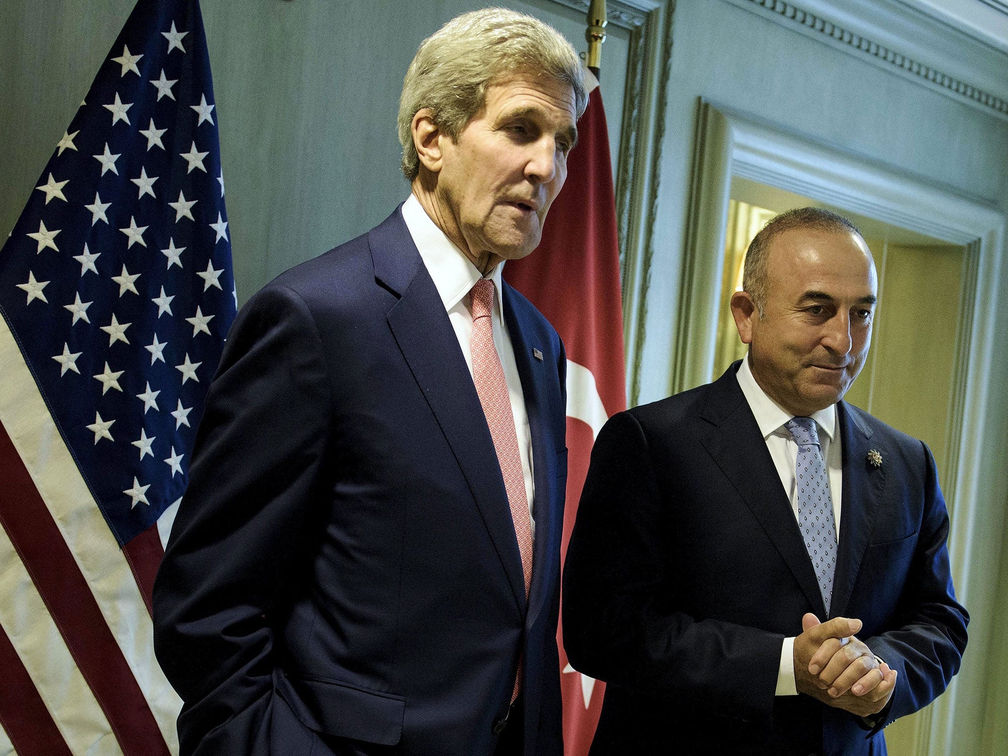 US Secretary of State John Kerry (L) and Turkey's Foreign Minister Mevlut Cavusoglu wait for a meeting in Kuala Lumpur on August 5, 2015
