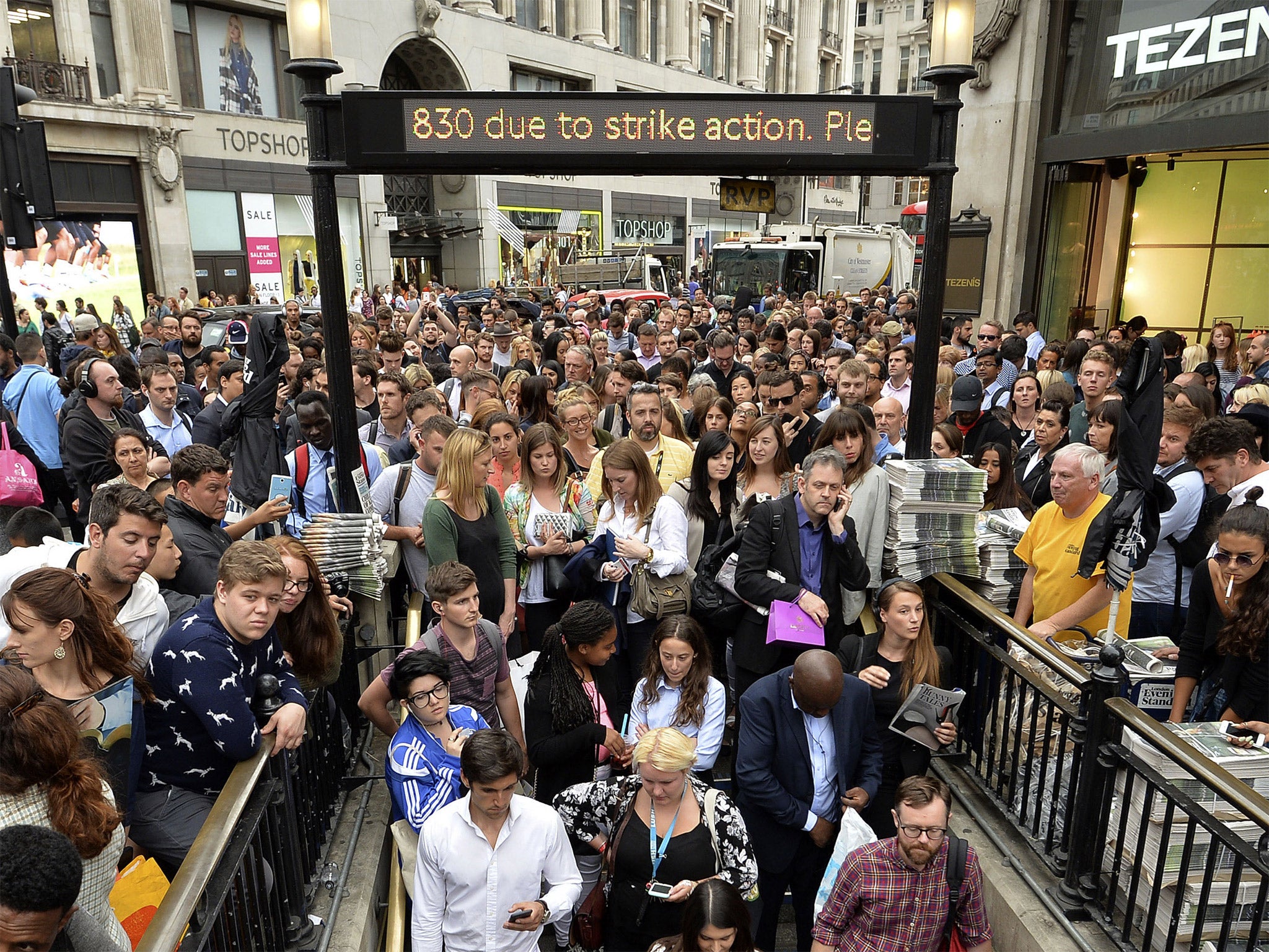 People queue outside an entrance to Oxford Circus underground tube station prior to the strike