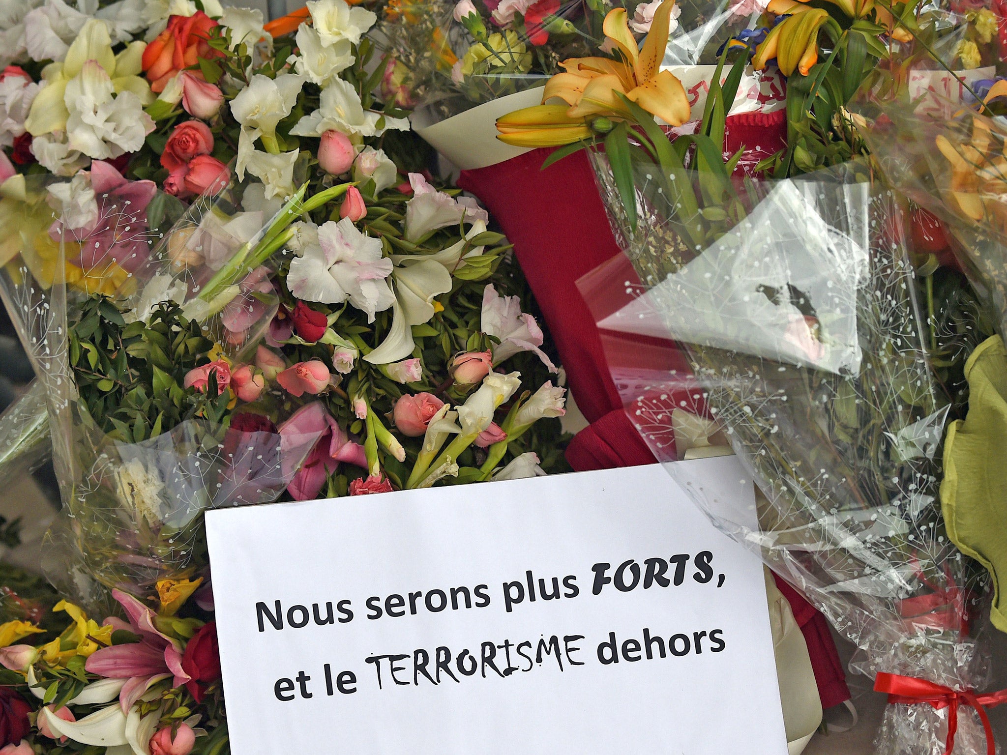 Flowers and a message reading in French: 'We will be stronger and and get rid of terrorism' laid outside the Bardo Museum following the attack in March