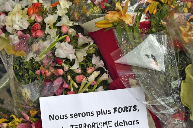 Flowers and a message reading in French: 'We will be stronger and and get rid of terrorism' laid outside the Bardo Museum following the attack in March