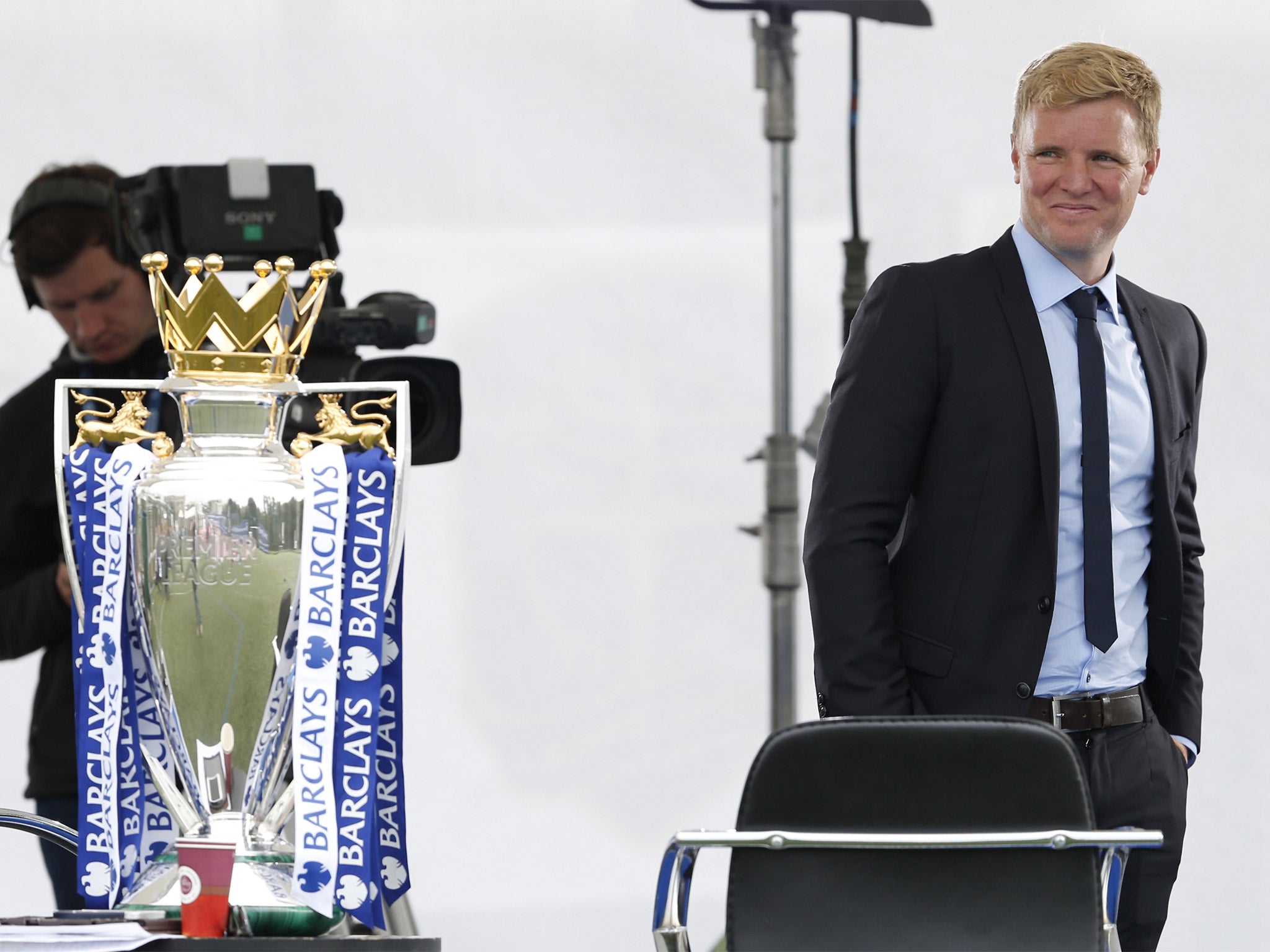 Eddie Howe sneaks a glance at the Premier League trophy at Southfields Academy in London