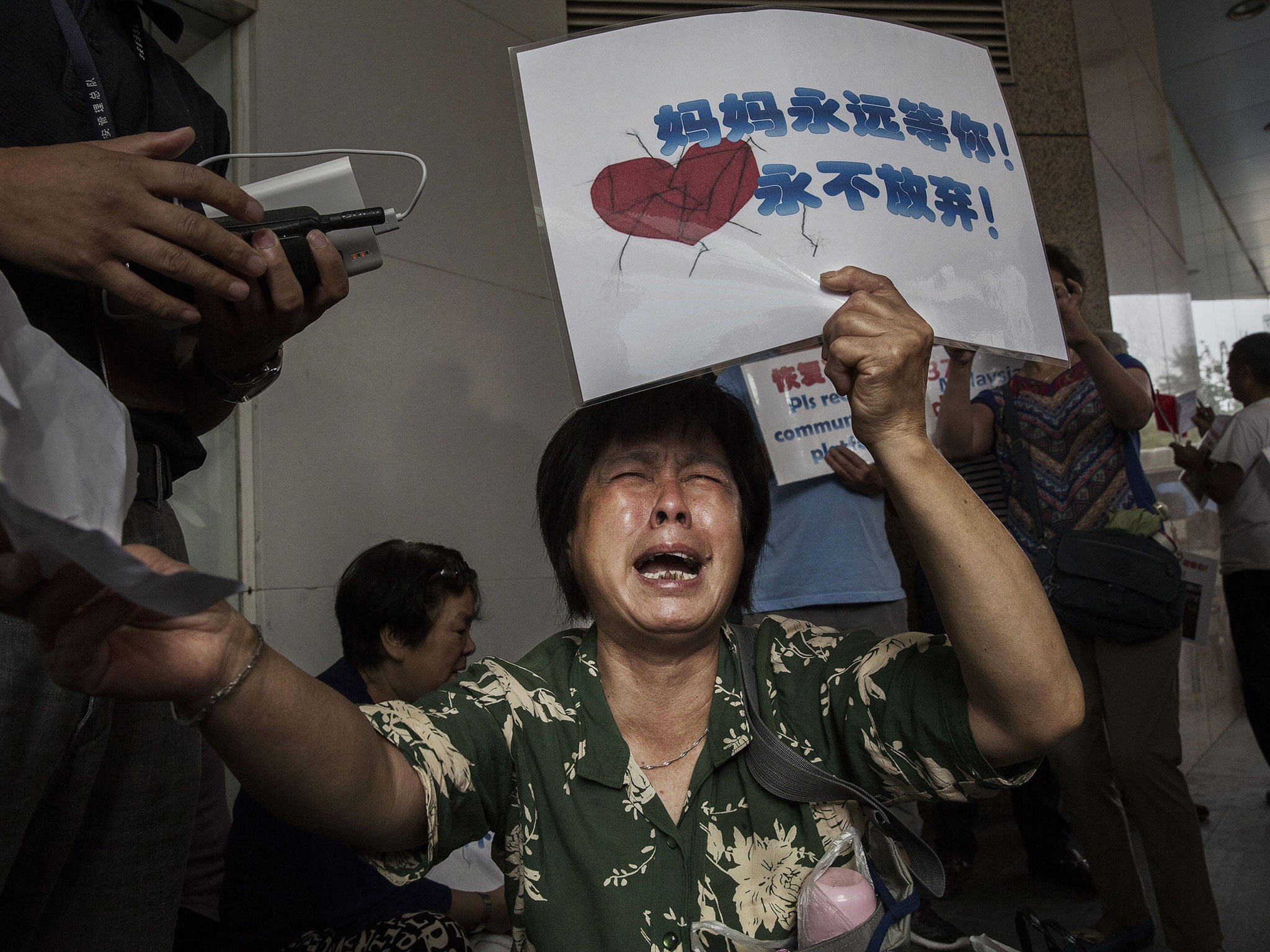 Bao Lanfang, a Chinese relative of missing passengers on Malaysia Airlines flight MH370, pictured as she waits for information outside the airlines office on August 6, 2015 in Beijing, China