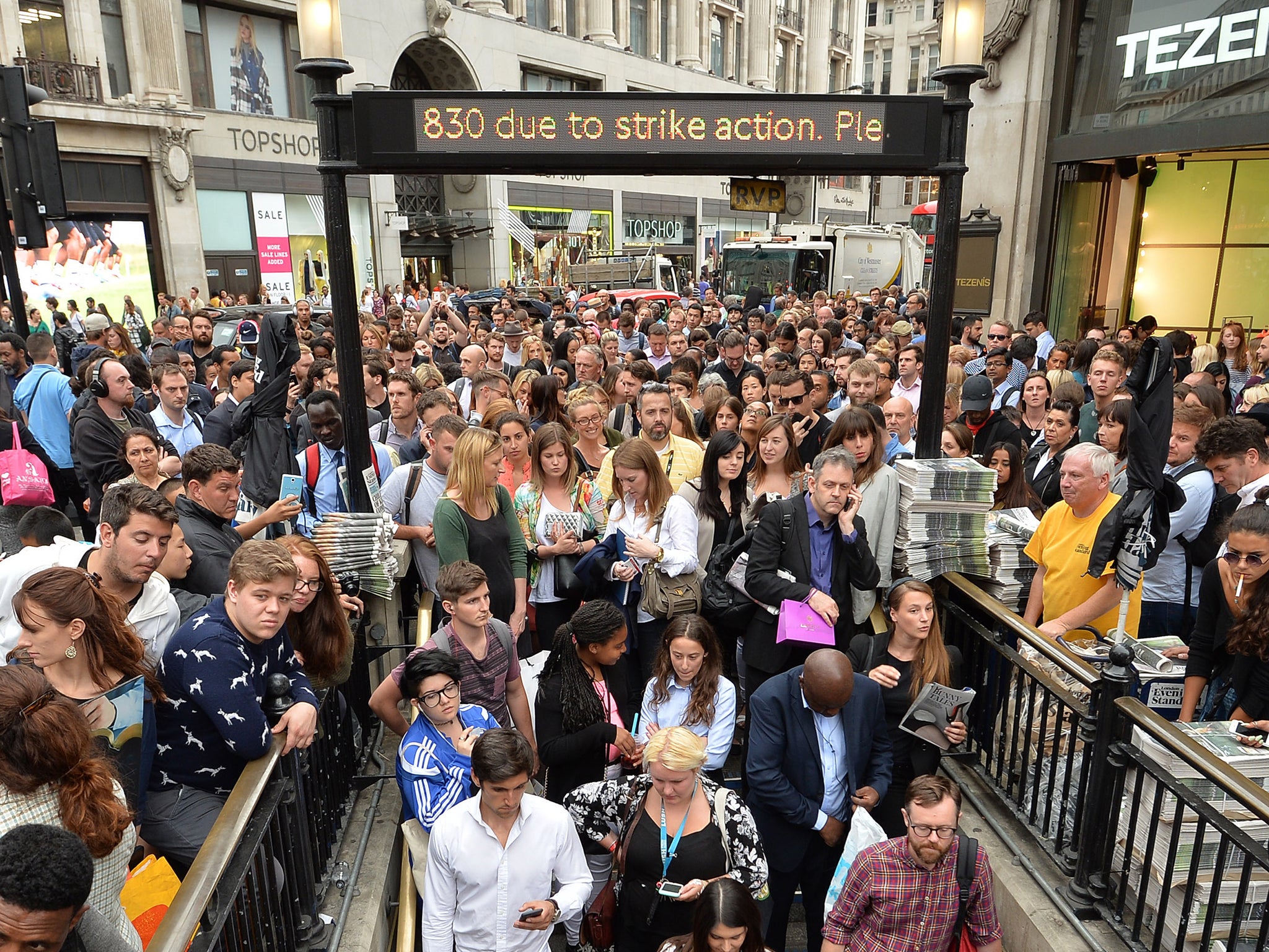 People queue at an entrance to Oxford Circus station, as workers try to get home before a strike by Underground workers closes the capital's entire Tube system
