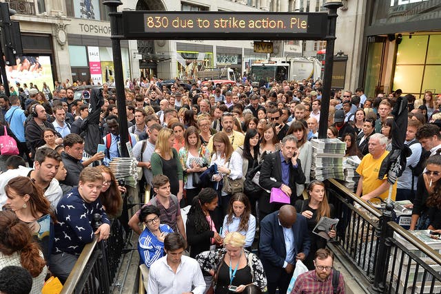 People queue at an entrance to Oxford Circus station, as workers try to get home before a strike by Underground workers closes the capital's entire Tube system