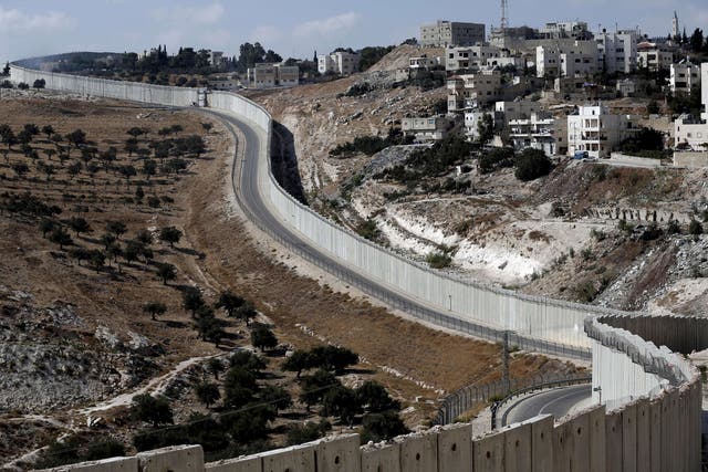 The Palestinian West bank city of Abu Dis is seen near the Israeli separation barrier