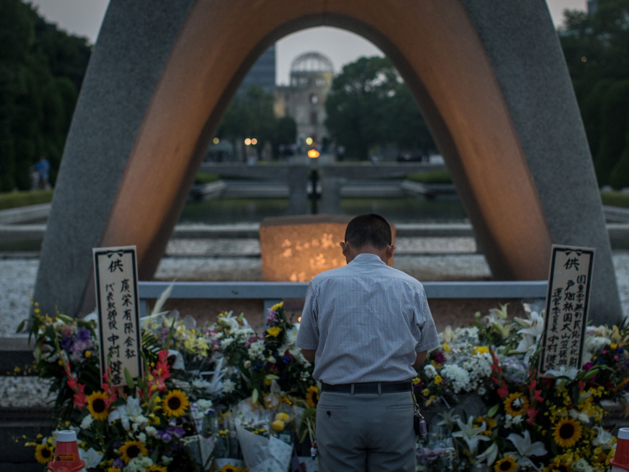 A man prays at the Hiroshima Peace Memorial ahead of the 70th anniversary ceremony of the atomic bombing of Hiroshima