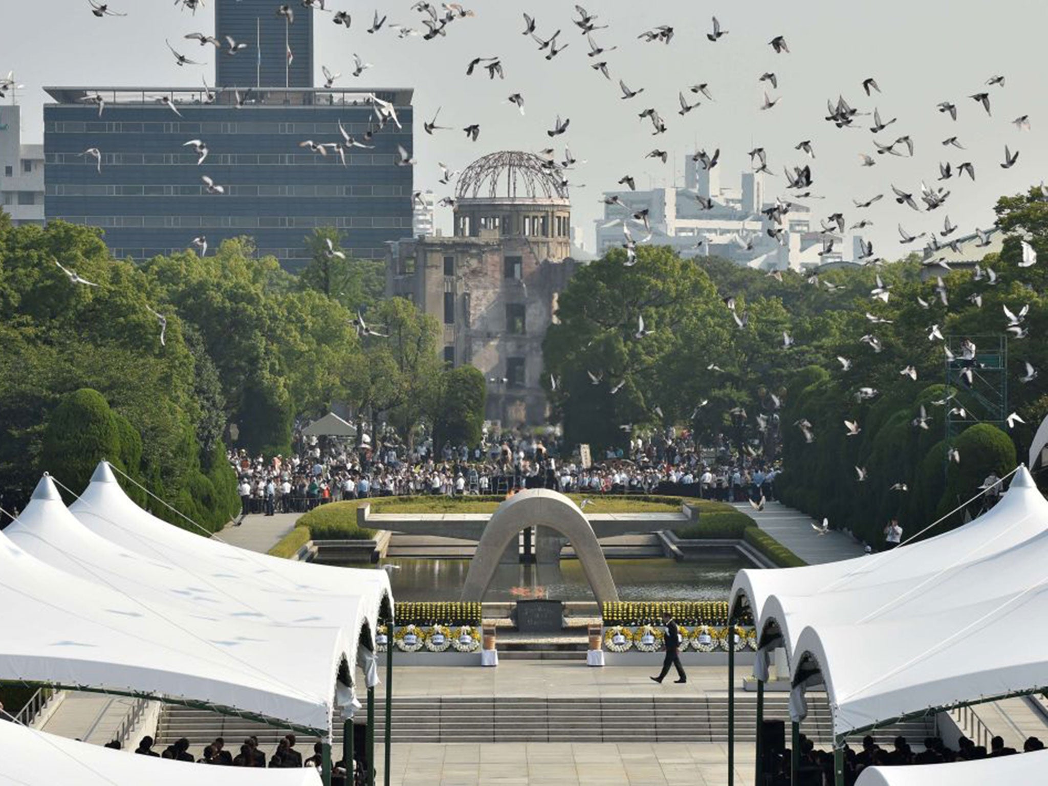 Doves fly over the Hiroshima Peace Memorial Park in western Japan on August 6, 2015