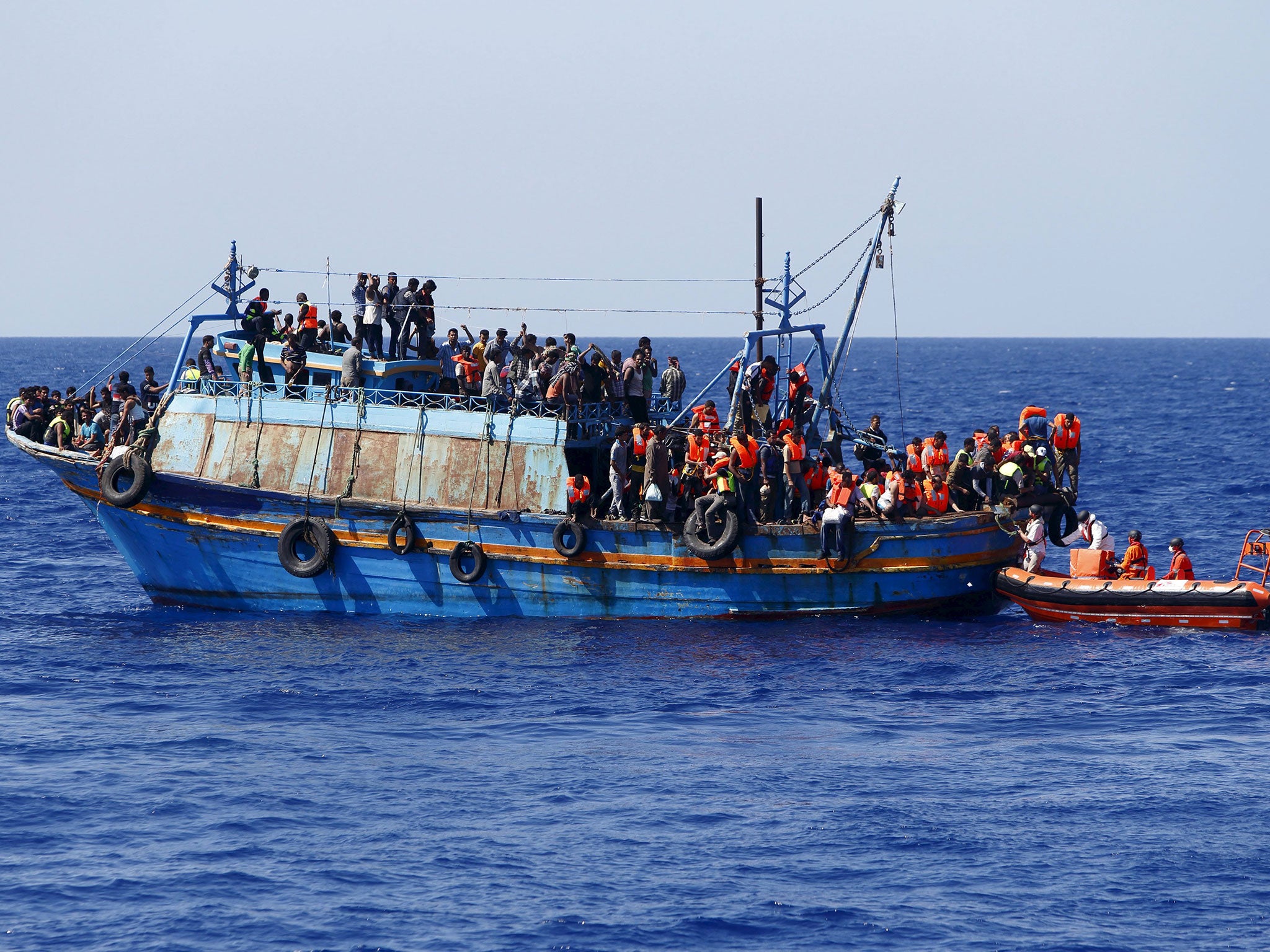 Migrants on board an overloaded wooden boat are rescued some 10.5 miles (16 km) off the coast of Libya August 6, 2015. (Reuters)