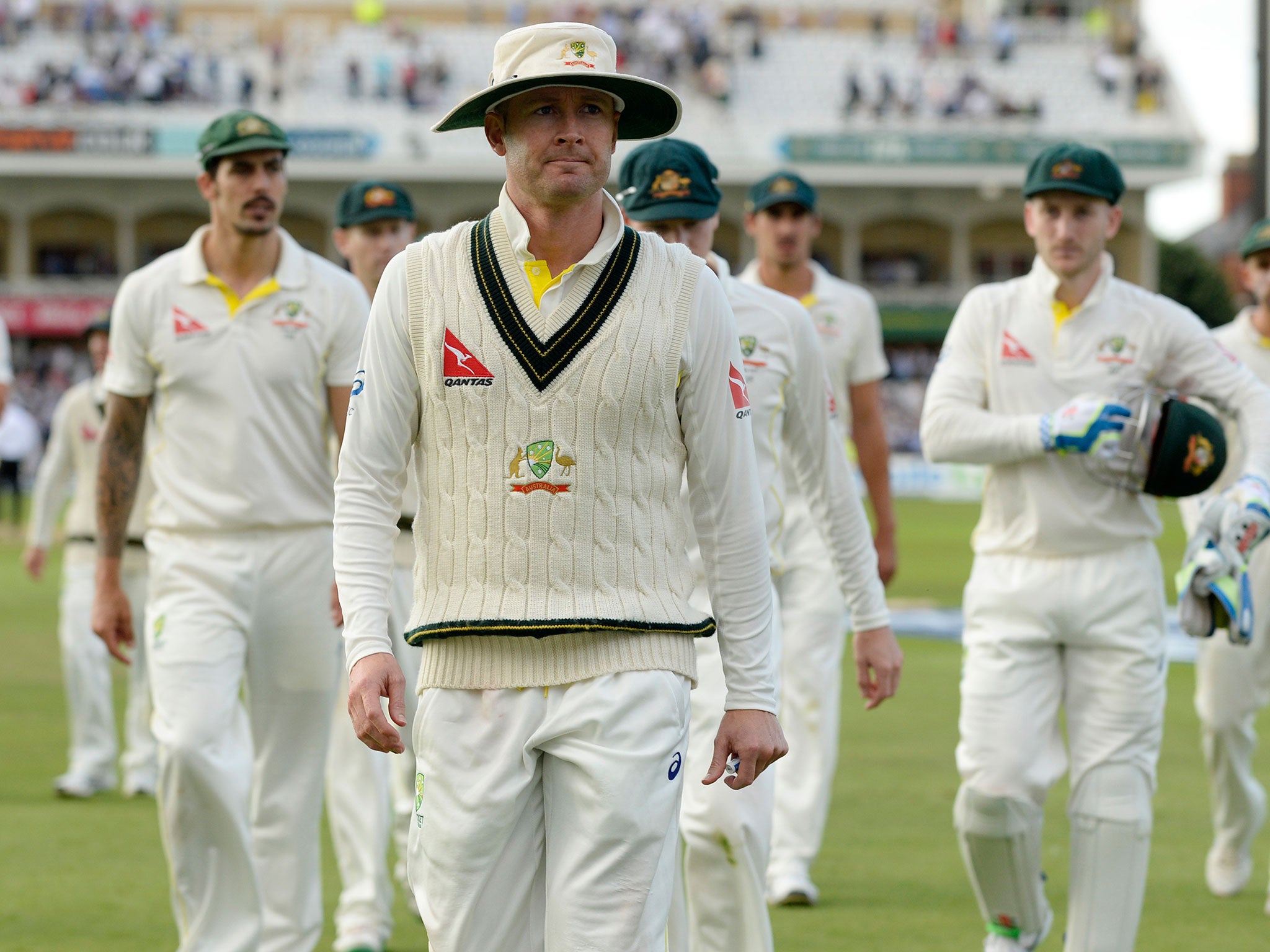 Michael Clarke leads his disgruntled troops from the field at close of play last night (Reuters)