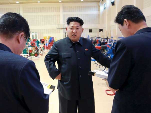 An undated image of Kim - released by state news - talking to officials