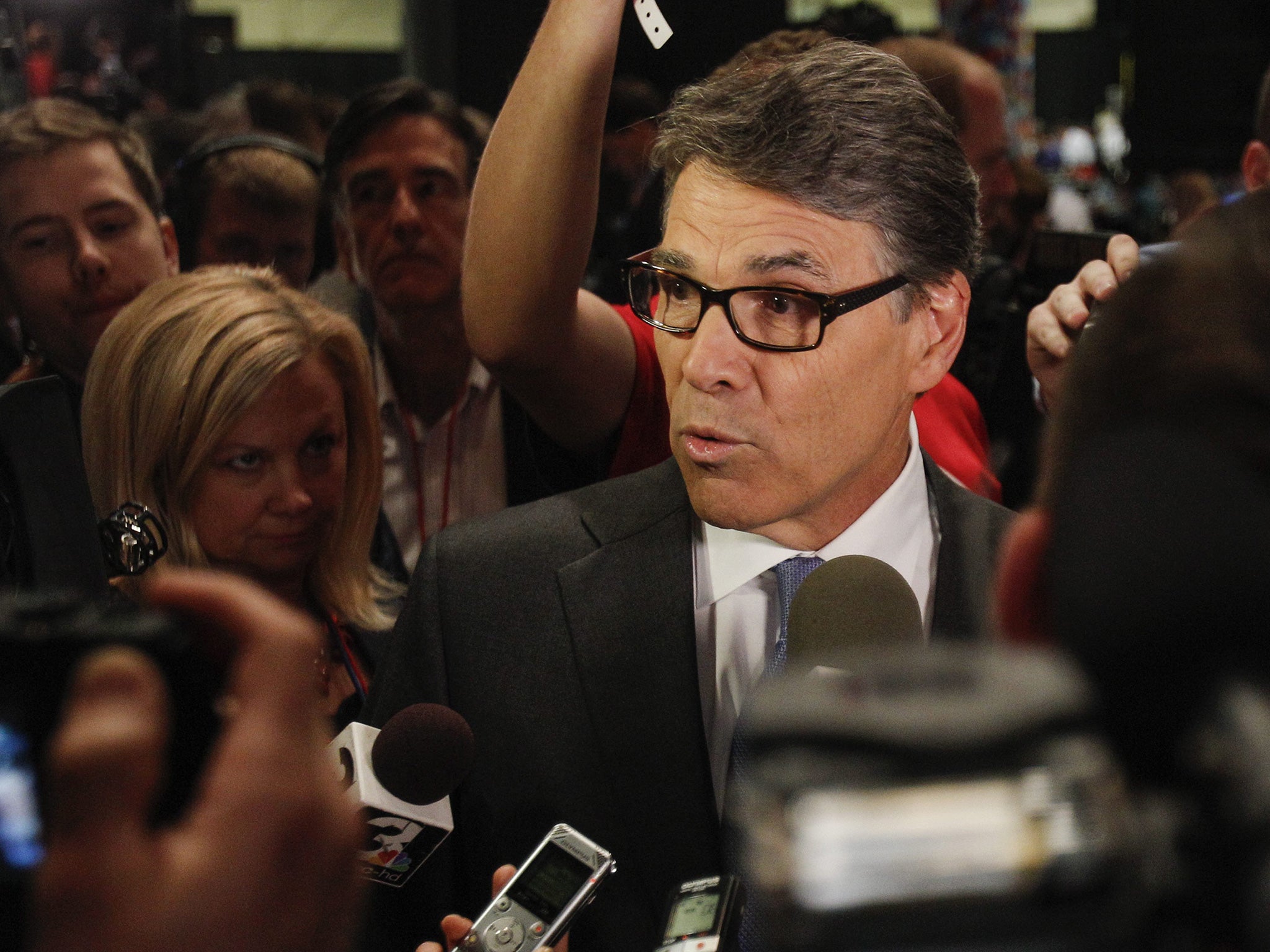 Rick Perry is questioned by journalists (EPA)