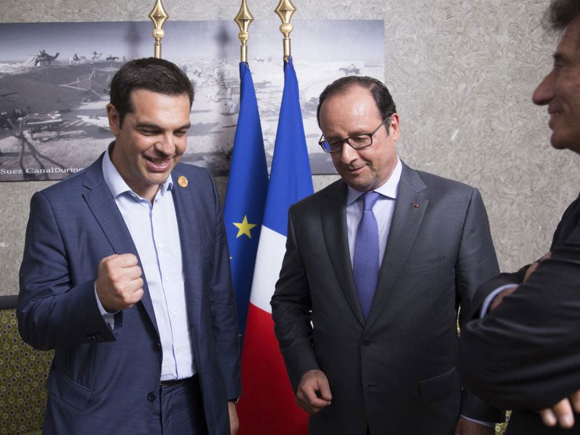 French President Francois Hollande, center, Greek Prime Minister Alexis Tsipras, left, and Jack Lang, head of the Institut du Monde Arabe (Arab World Institute), meet on the occasion of the inauguration of a new Suez Canal waterway, in Ismailia, Egypt