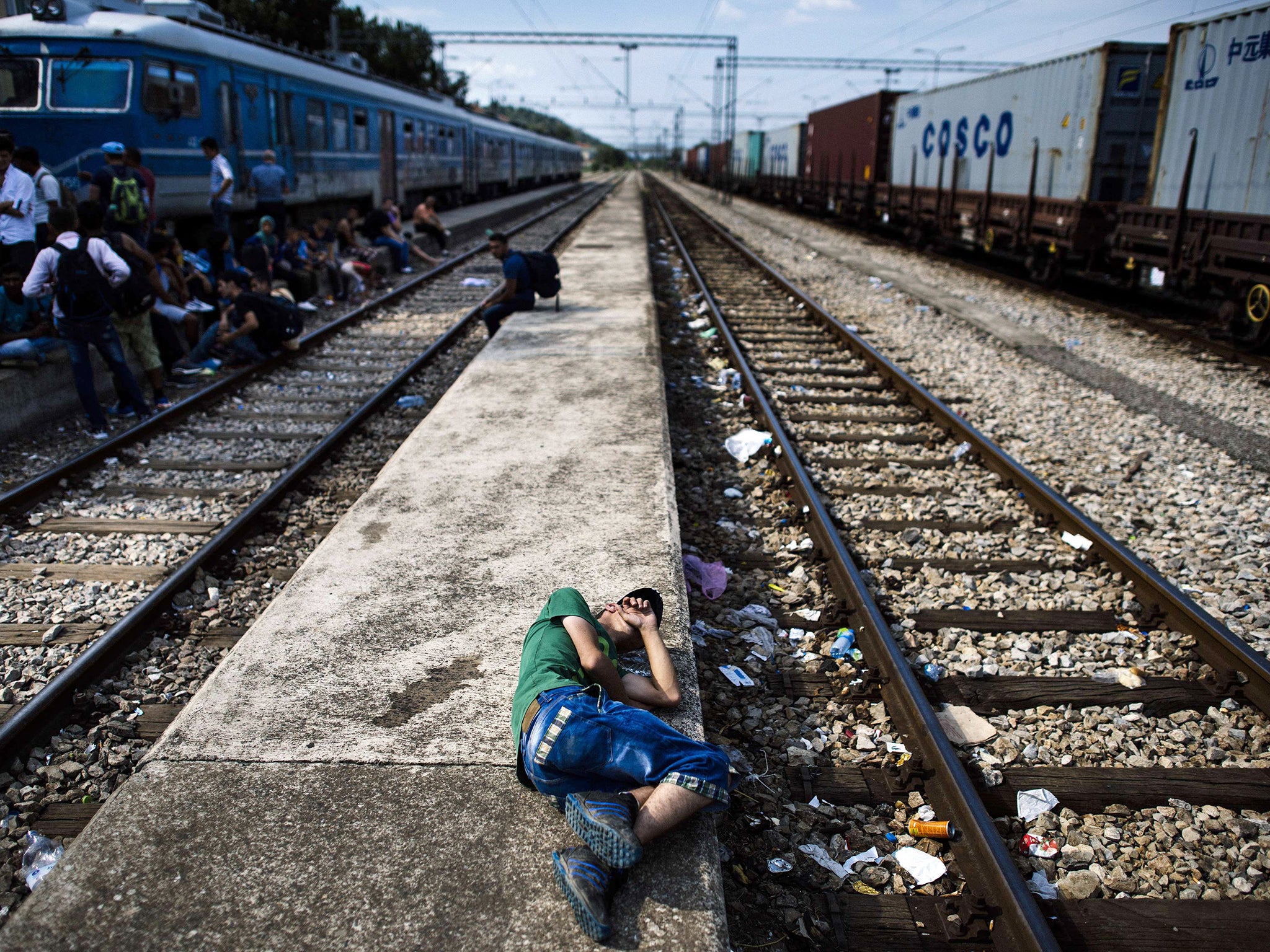 A migrant man rests on a platform at the train station in Gevgelija, on the Macedonian-Greek border