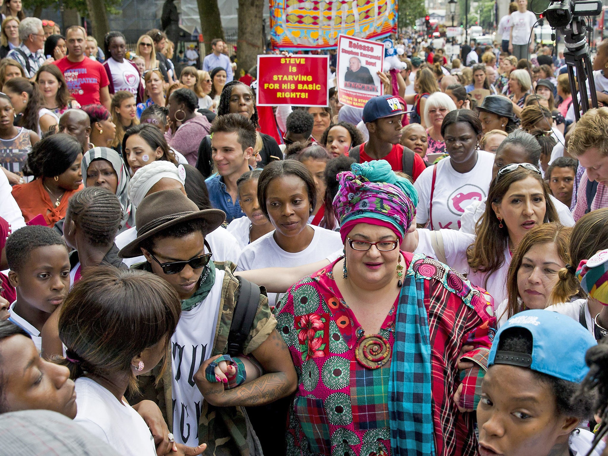 Iranian-born British charity executive Camila Batmanghelidjh (centre), founder of the children's charity Kids Company, leaves surrounded by supporters after speaking at a protest over the closure of Kids Company outside Downing Street in London