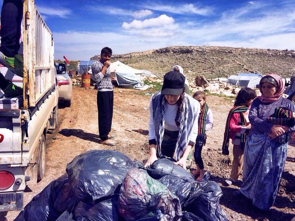 Sindy at the top of Shingal/Sinjar mountain distributing clothes, blankets, shoes and toys.