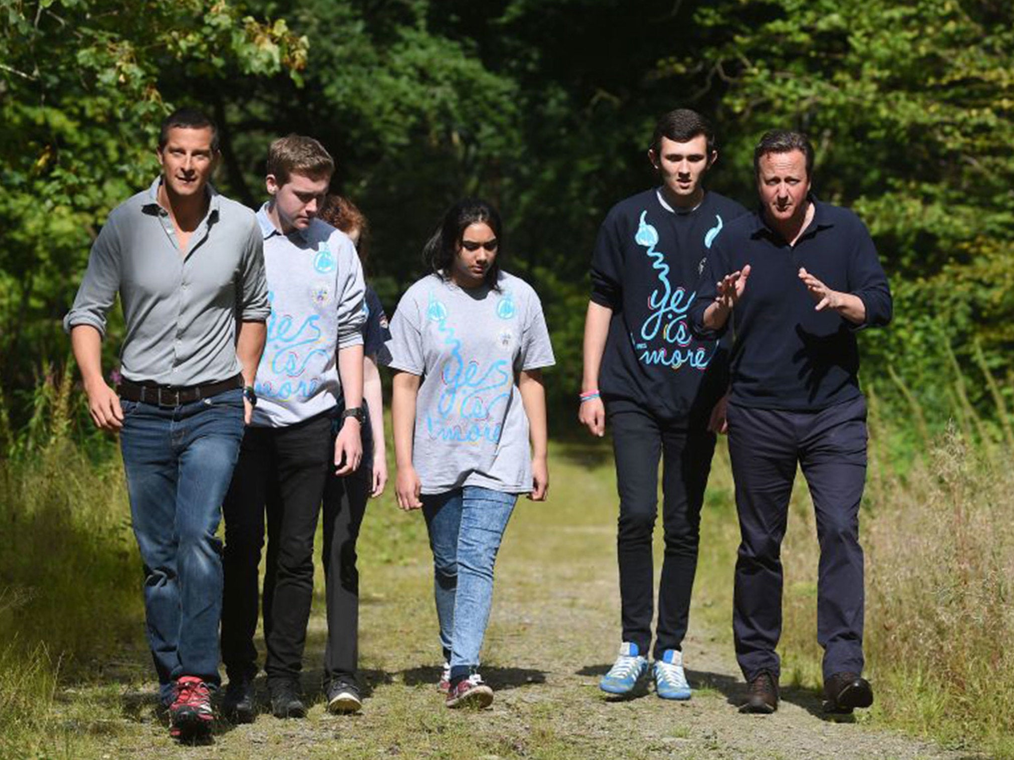 Prime Minister David Cameron (right) and survival expert Bear Grylls (left) talk to members of the National Citizen Service during a visit to Oaklands Outdoor Education Centre in Snowdonia