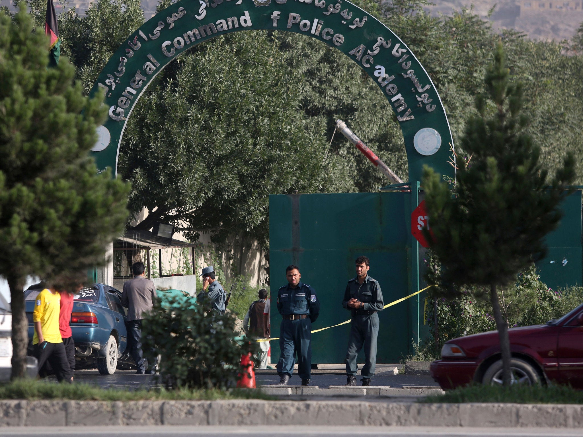 Afghanistan's national police stand guard at the entrance gate of Police Academy