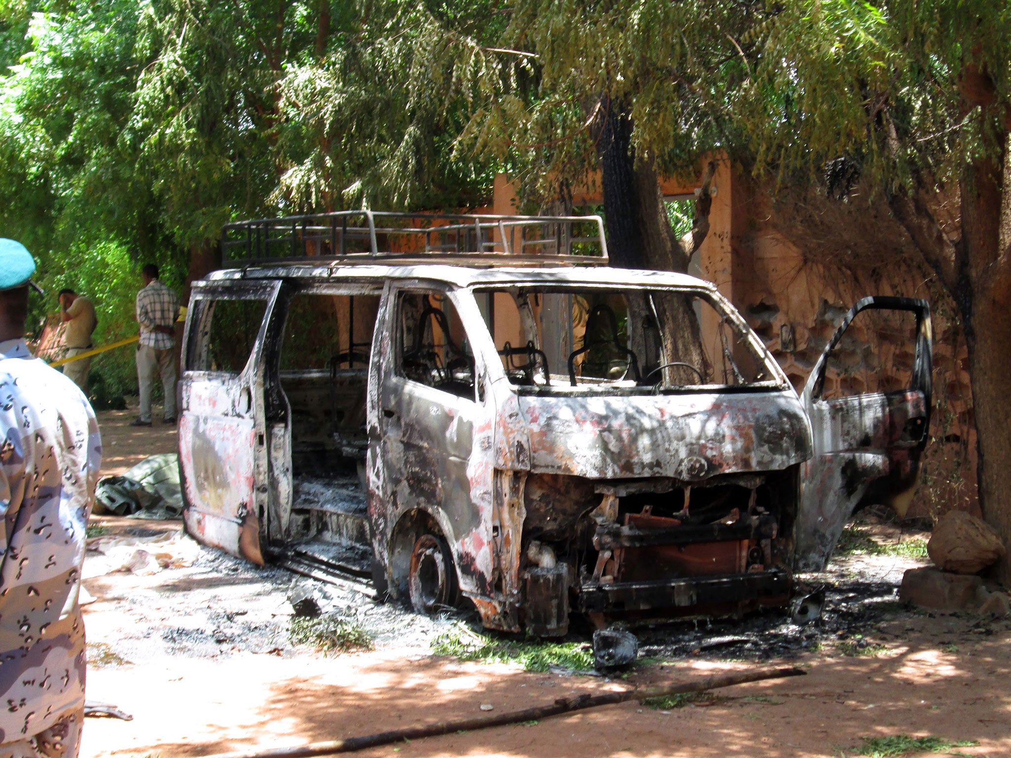 A burned vehicle in front of the Hotel Byblos in the central Malian town of Sevare, after gunmen stormed the hotel on August 7