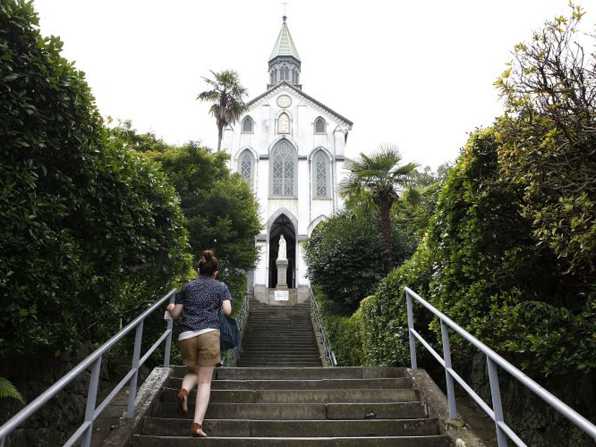 A woman visits Oura Church, the oldest church in Japan, also known as the Church of the 26 Japanese Martyrs