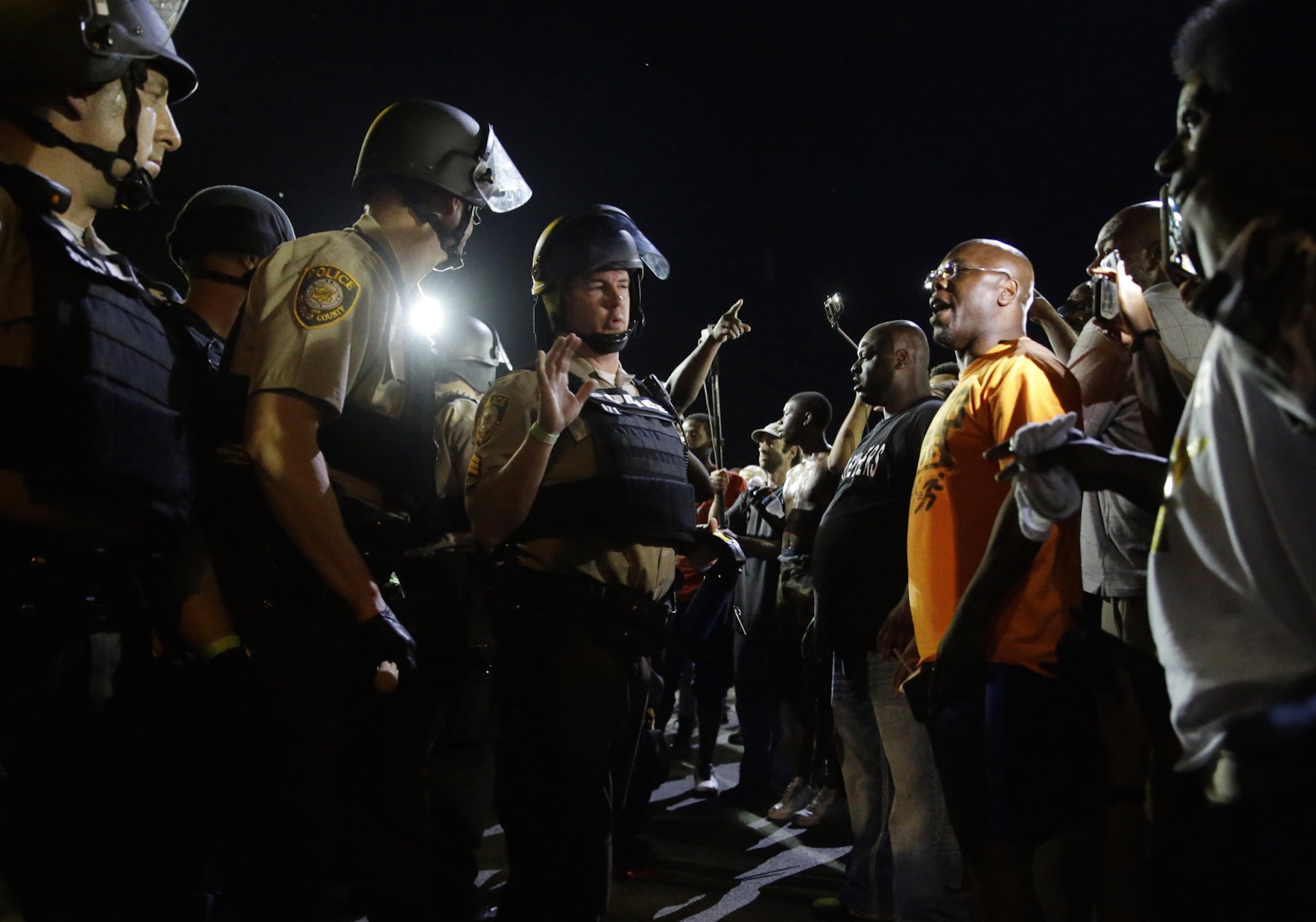 Officers and protesters face off along West Florissant Avenue on Monday.