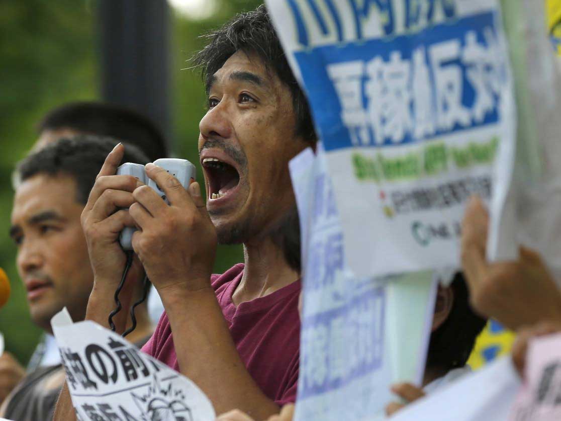 Protesters demonstrate against the plants reopening